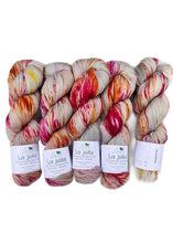 Five skeins of multicolored yarn with 'La Jolla' labels on a white background
