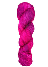 Pink skein of yarn on a white background baah yarn La Jolla fingering weight yarn hand dyed