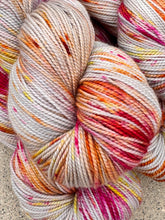 Multicolored skein of yarn on a textured surface of the baah yarn La Jolla 